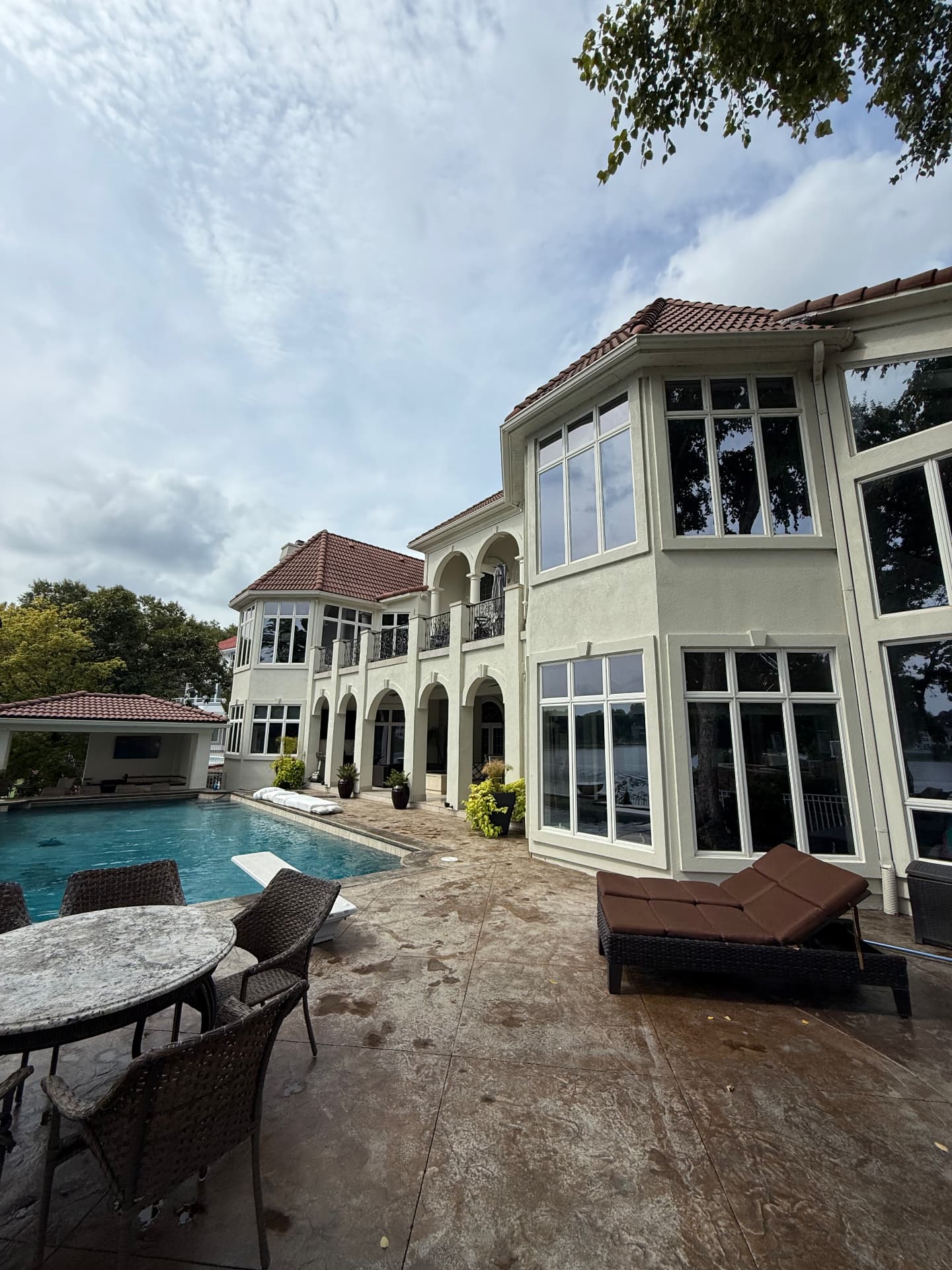 Lakefront estate with clean windows and washed pool decking