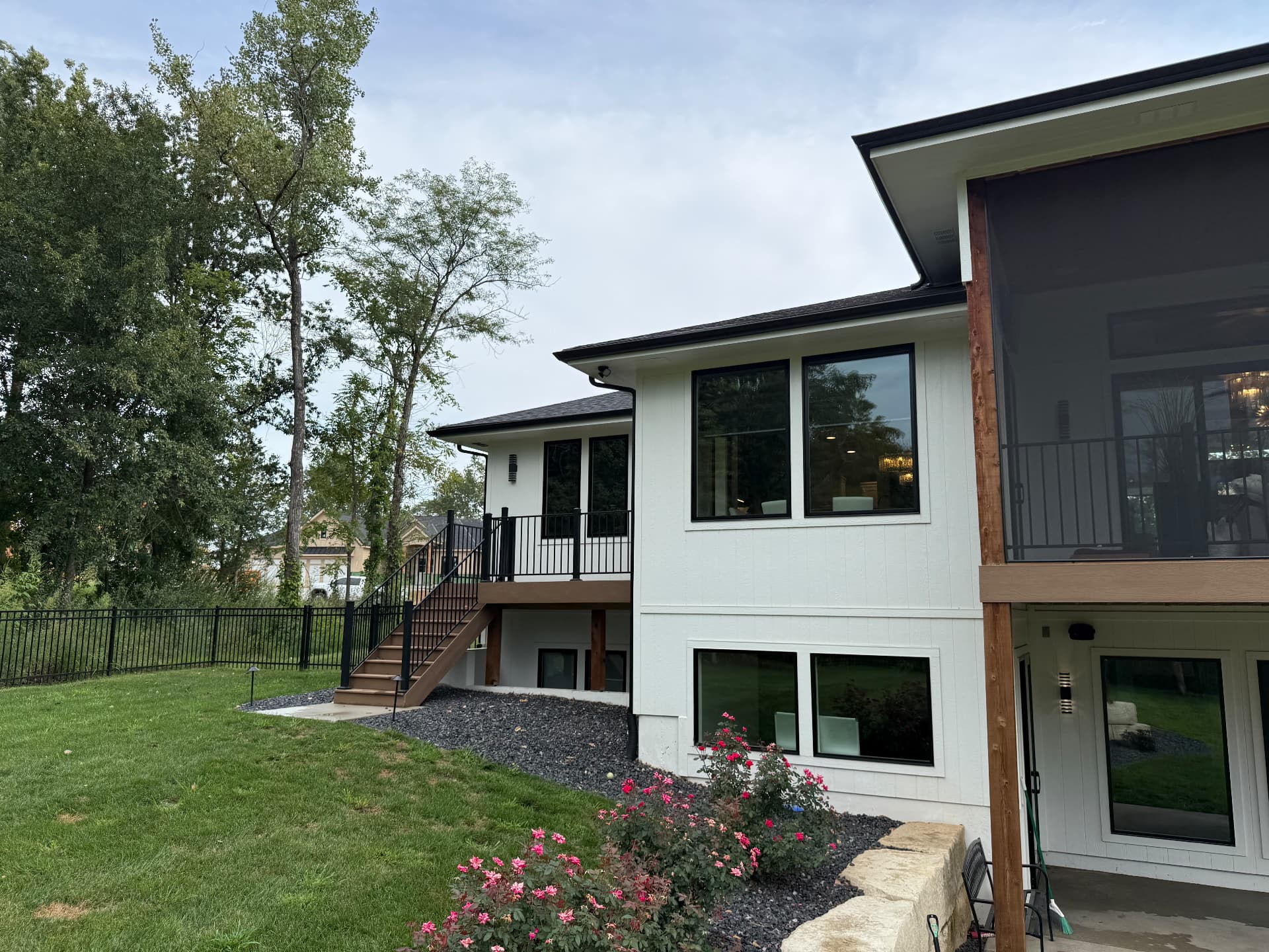 Two-story white home with clean gutters, siding and windows