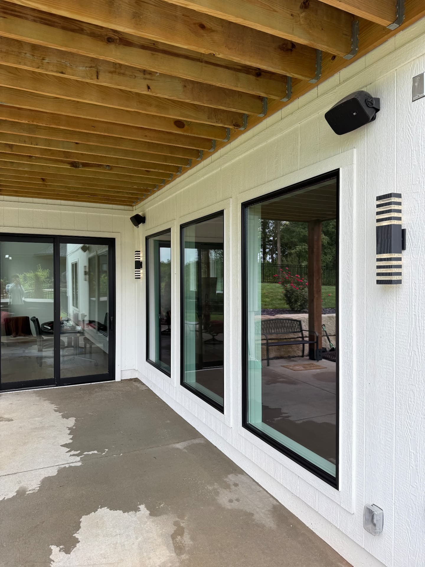 Covered patio with spotless sliding glass doors and clean concrete